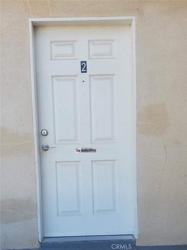 view of exterior entry with stucco siding