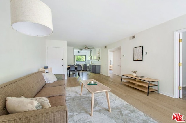 living room with ceiling fan and light hardwood / wood-style floors