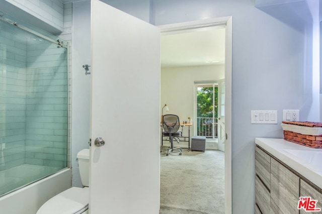 full bathroom featuring shower / bath combination with glass door, vanity, and toilet