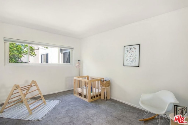 bedroom with carpet flooring and a nursery area