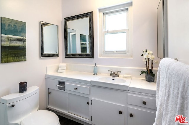 bathroom with vanity and toilet