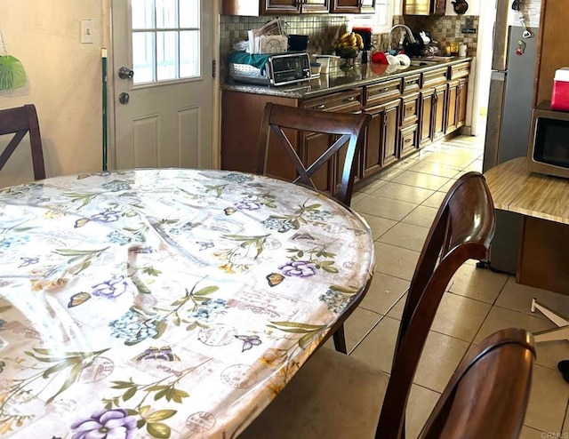 tiled dining area featuring sink