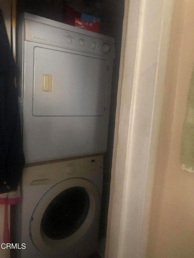 laundry room featuring stacked washer and clothes dryer