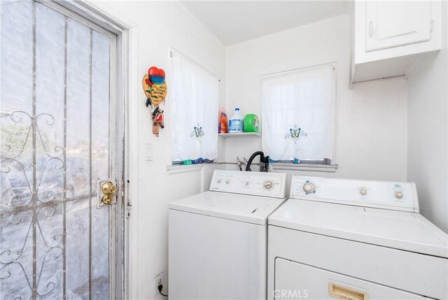 washroom featuring cabinets and independent washer and dryer