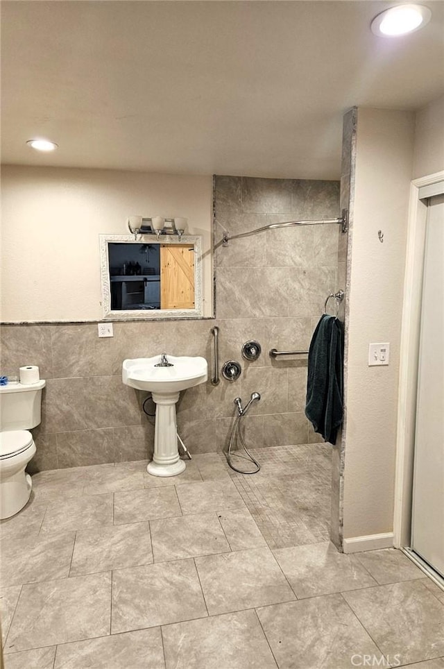 bathroom with toilet and tile walls