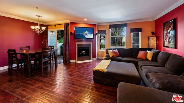 living room with a notable chandelier, plenty of natural light, dark wood-type flooring, and crown molding