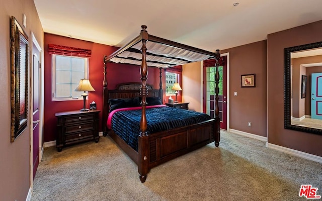 bedroom featuring light carpet