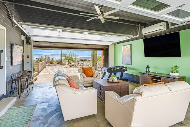 interior space featuring concrete floors, ceiling fan, and a wall mounted AC