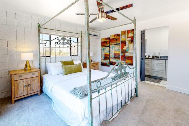 bedroom with ensuite bath, ceiling fan, and light colored carpet