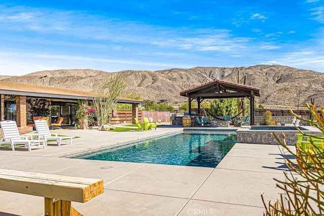 view of pool featuring a mountain view, a patio area, and a gazebo