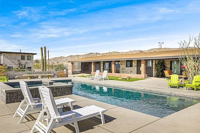 view of pool featuring a patio and a mountain view