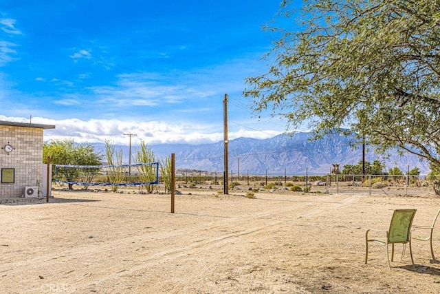 exterior space with a mountain view, volleyball court, and a rural view