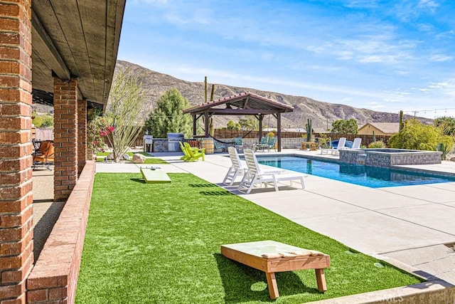 view of pool featuring a mountain view, a patio, a gazebo, and an in ground hot tub