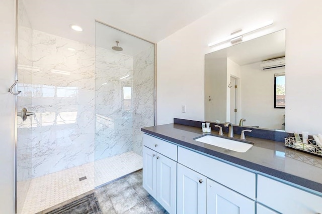 bathroom featuring vanity, a tile shower, and a wall mounted AC