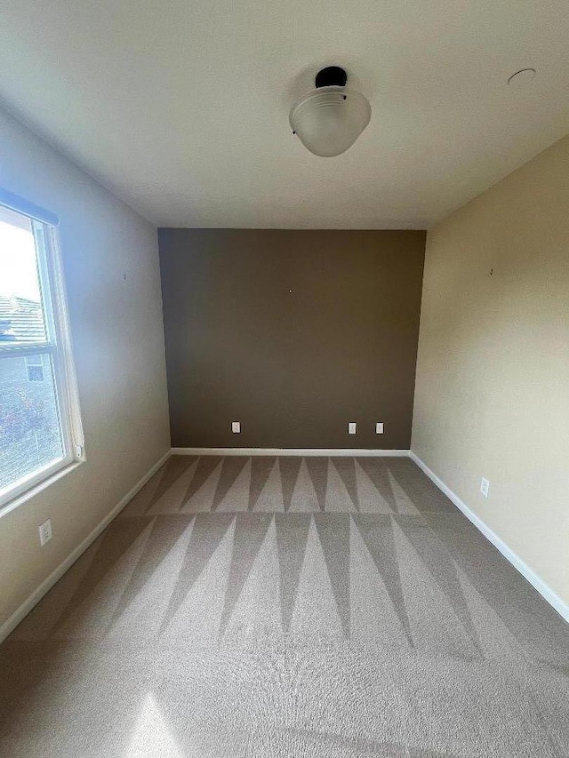 unfurnished room with carpet floors