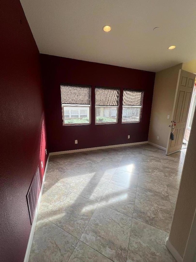 unfurnished room featuring plenty of natural light