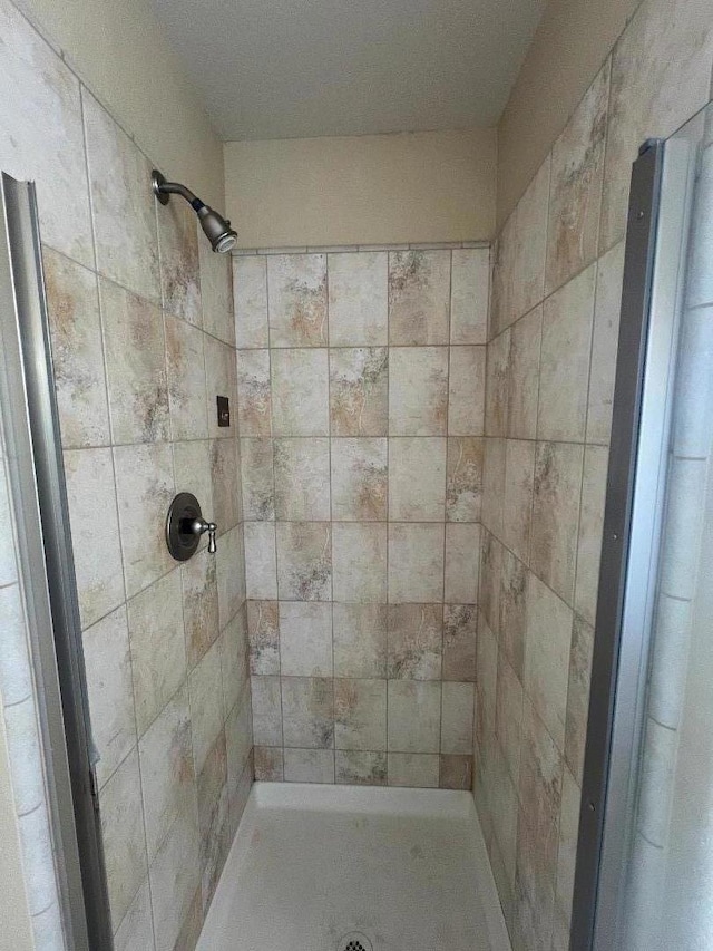 bathroom with tiled shower