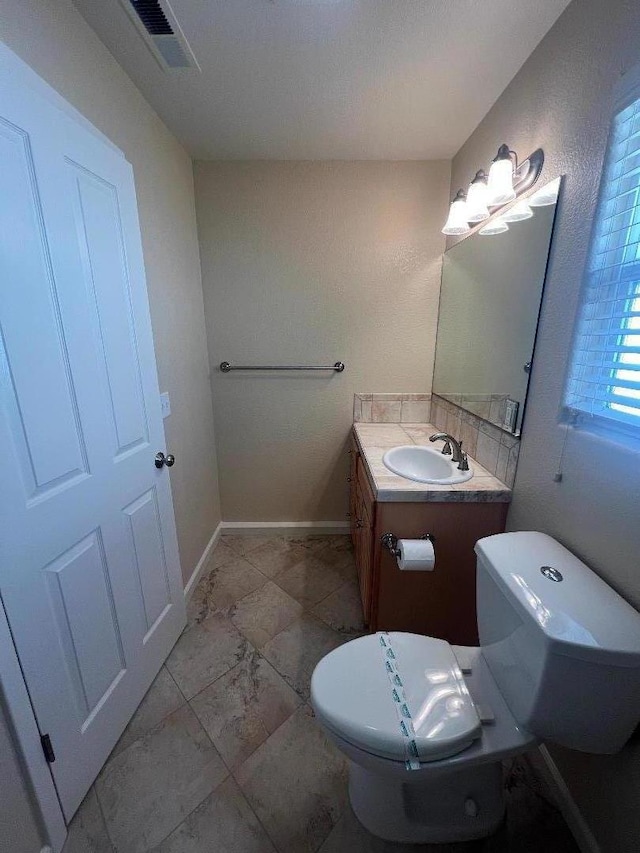 bathroom featuring vanity and toilet