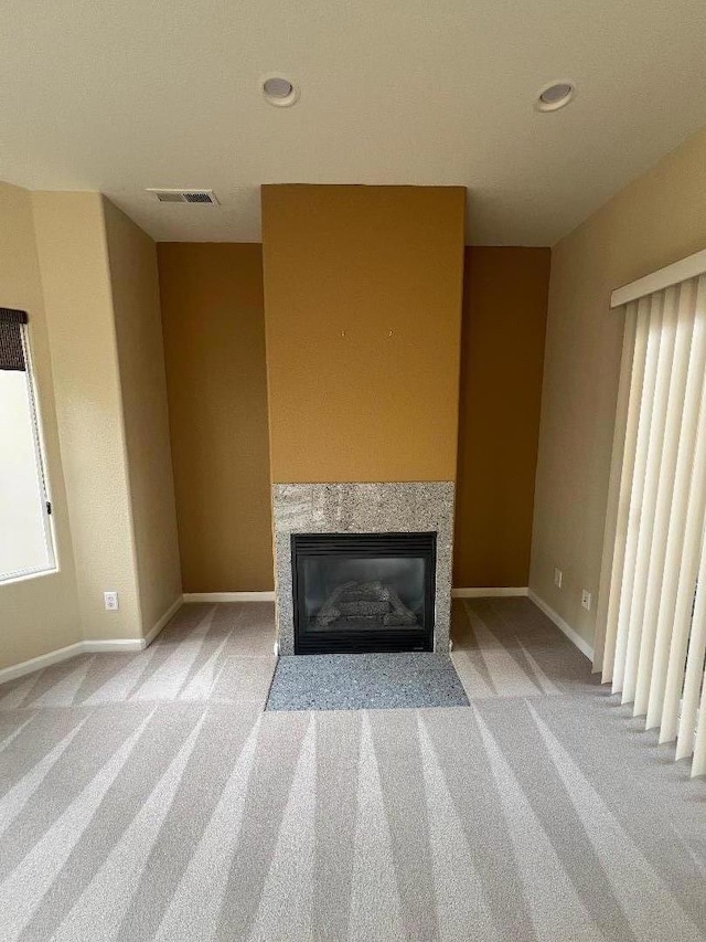 unfurnished living room featuring light carpet