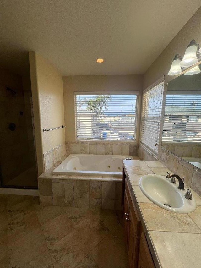 bathroom with vanity, tile patterned floors, and plus walk in shower