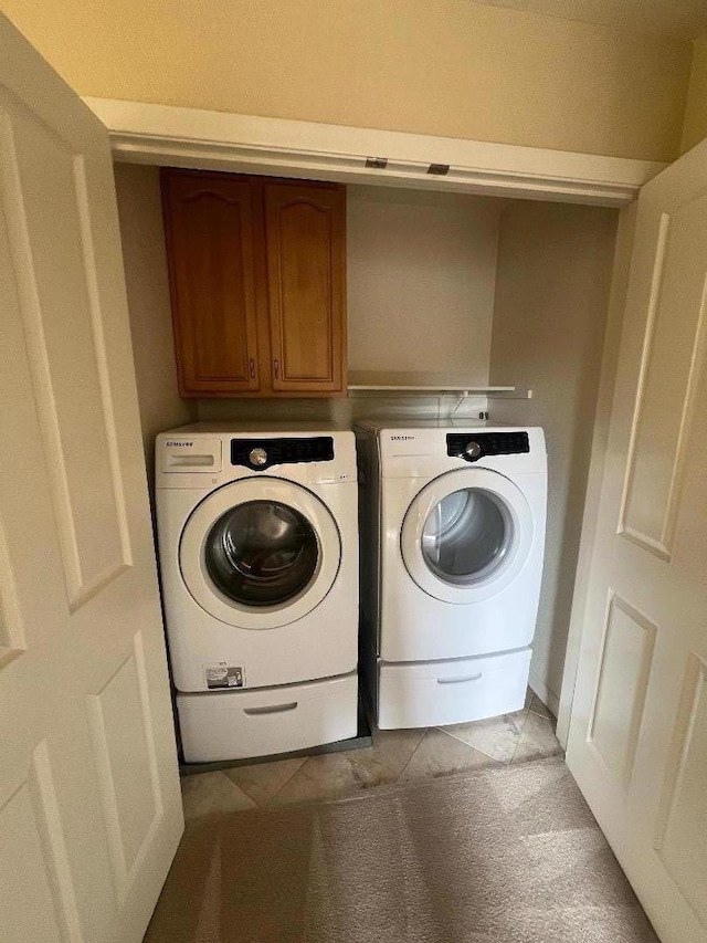 laundry area with cabinets and washing machine and dryer