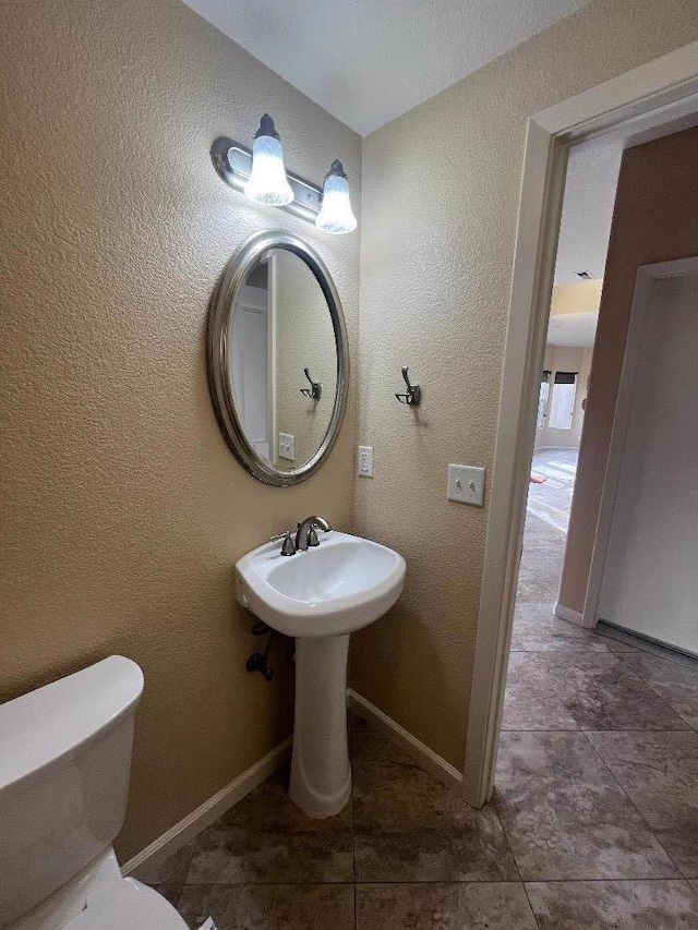 bathroom with tile patterned floors, toilet, and sink