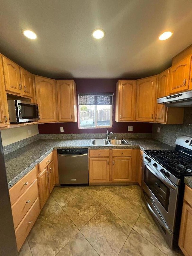 kitchen with light tile patterned flooring, stainless steel appliances, and sink