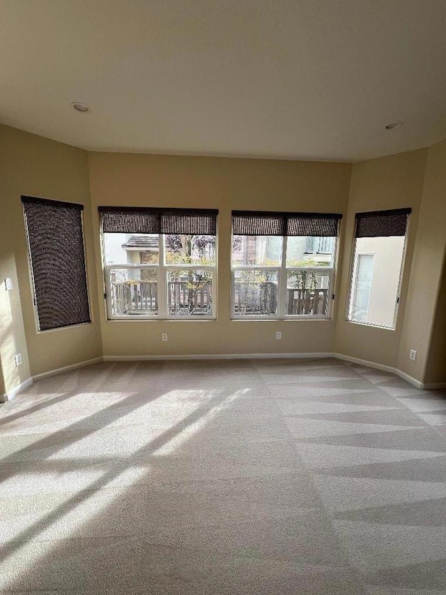 unfurnished room featuring light colored carpet