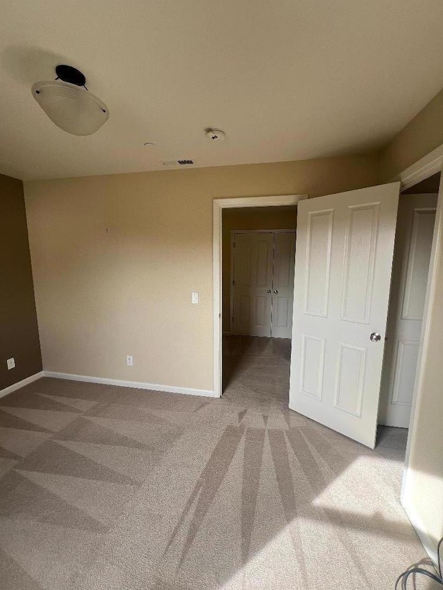 unfurnished bedroom with carpet floors