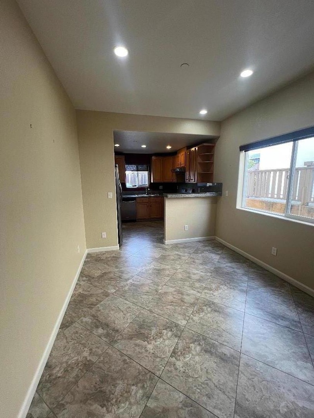 unfurnished living room featuring sink