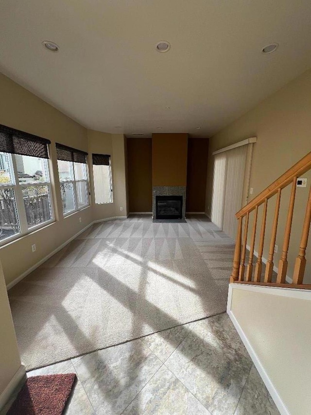 unfurnished living room featuring light carpet