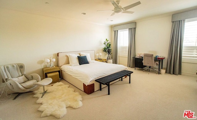 carpeted bedroom with ornamental molding and ceiling fan