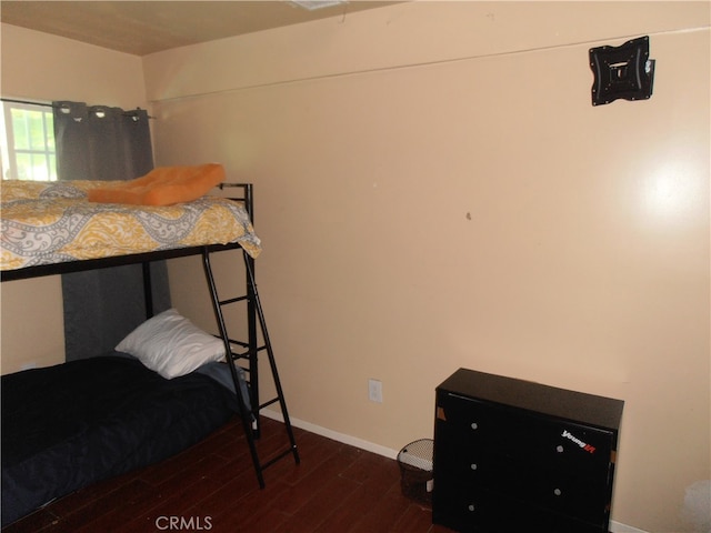 bedroom with dark hardwood / wood-style floors