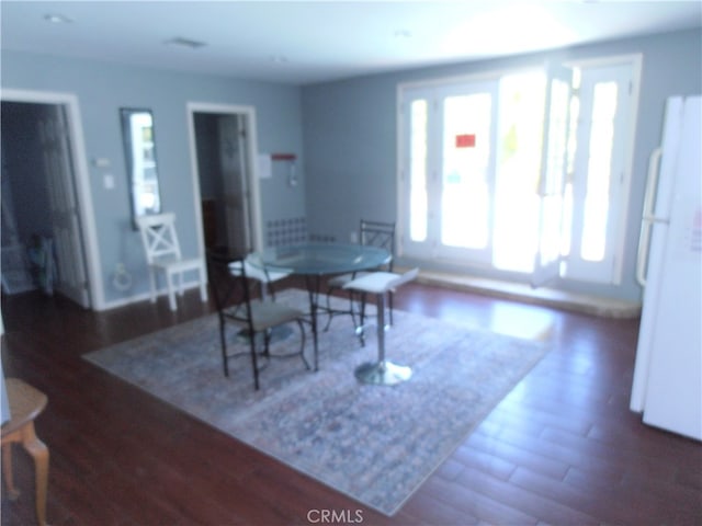 dining space featuring dark wood-type flooring