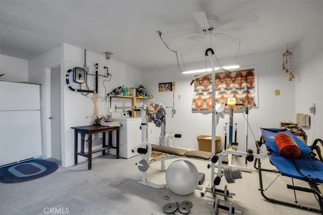 workout area featuring ceiling fan and washer / dryer