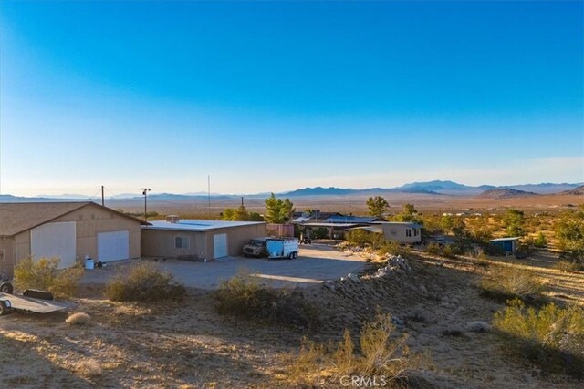 5975 Desert Star Rd Unit 1-2, Johnson Valley, CA 92285 - view of front of house featuring a mountain view and a garage