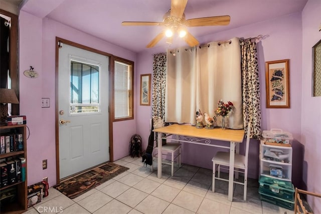 tiled entryway featuring ceiling fan