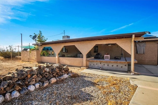 5975 Desert Star Rd Unit 1-2, Johnson Valley, CA 92285 - view of property exterior featuring a ceiling fan, a patio area, and stucco siding