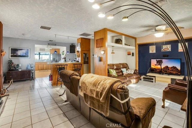 5975 Desert Star Rd Unit 1-2, Johnson Valley, CA 92285 - living area featuring visible vents, a ceiling fan, a textured ceiling, and light tile patterned flooring