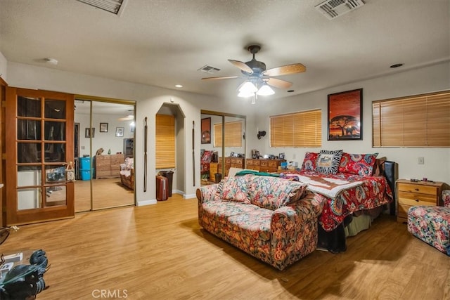 bedroom featuring ceiling fan, a textured ceiling, and light wood-type flooring