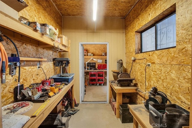 interior space with wooden walls and concrete floors