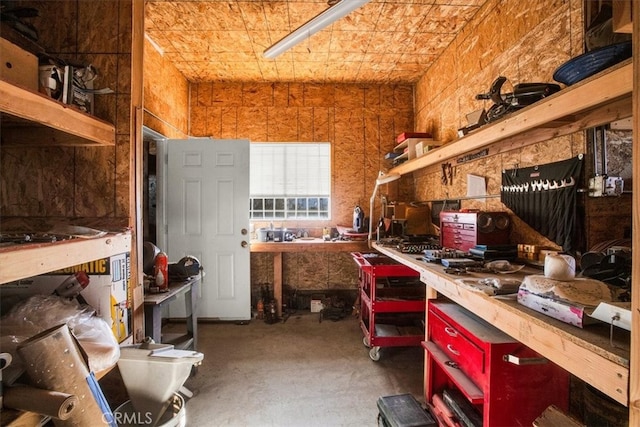 misc room with a workshop area and concrete floors