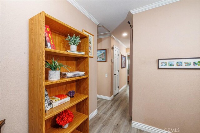 hall with hardwood / wood-style flooring and crown molding