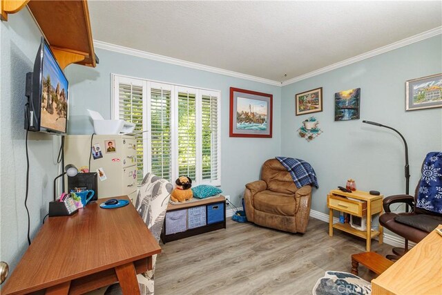 living area featuring ornamental molding and light hardwood / wood-style flooring