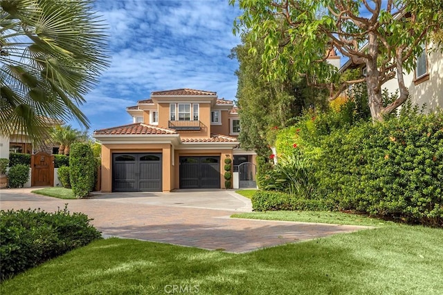 mediterranean / spanish house with a front yard and a garage