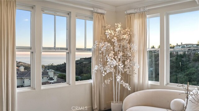 sunroom / solarium with a water view