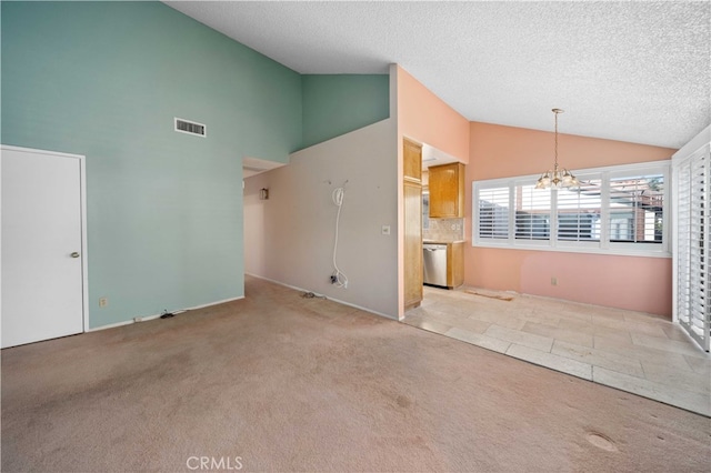 unfurnished living room featuring light carpet, a textured ceiling, a notable chandelier, and high vaulted ceiling