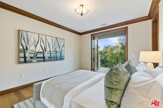 bedroom featuring access to outside, crown molding, and hardwood / wood-style flooring