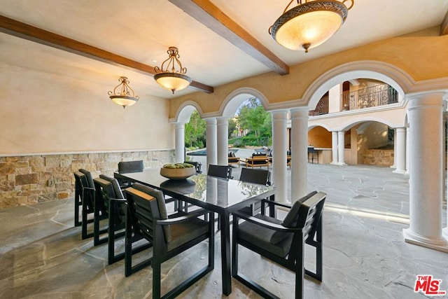 dining space featuring beam ceiling and decorative columns