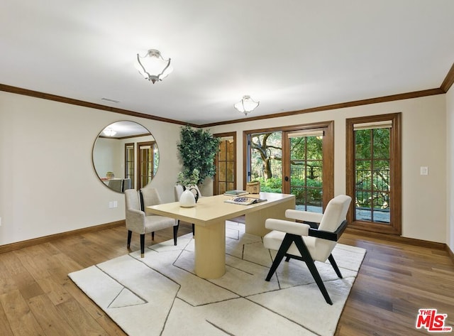 dining room featuring french doors, hardwood / wood-style flooring, and ornamental molding